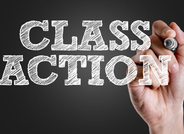 Hand holding a marker with Class Action concept