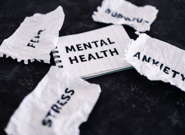 Mental health text on notepad surrounded by Fear Anxiety Stress