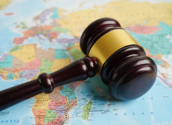 Bangkok, Thailand - May 15, 2022 Judges gavel on world map.