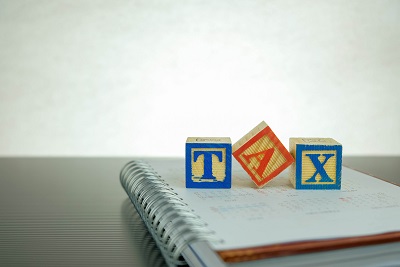 Conceptual image of annual tax return. Stacked wooden block lett