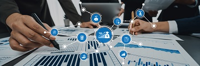 Hands Analyzing Financial Documents with Tax Symbols and Data Graphs in a Modern Office Environment. Amity