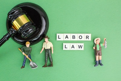 judge's hammer and labor workers with the word labor law. Labour law concept