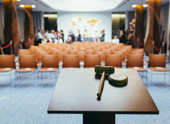 Hammer for the auction, on the background of the conference hall
